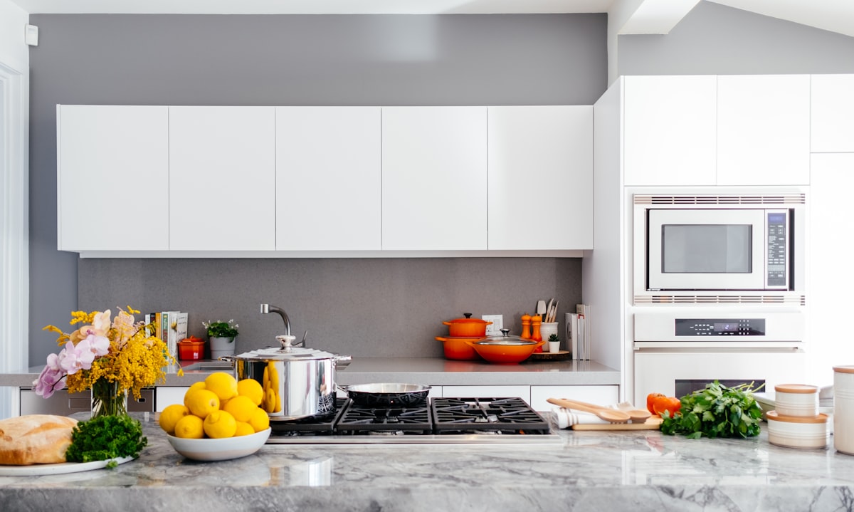 Clean, fully equipped shared kitchen with fresh food on the counter